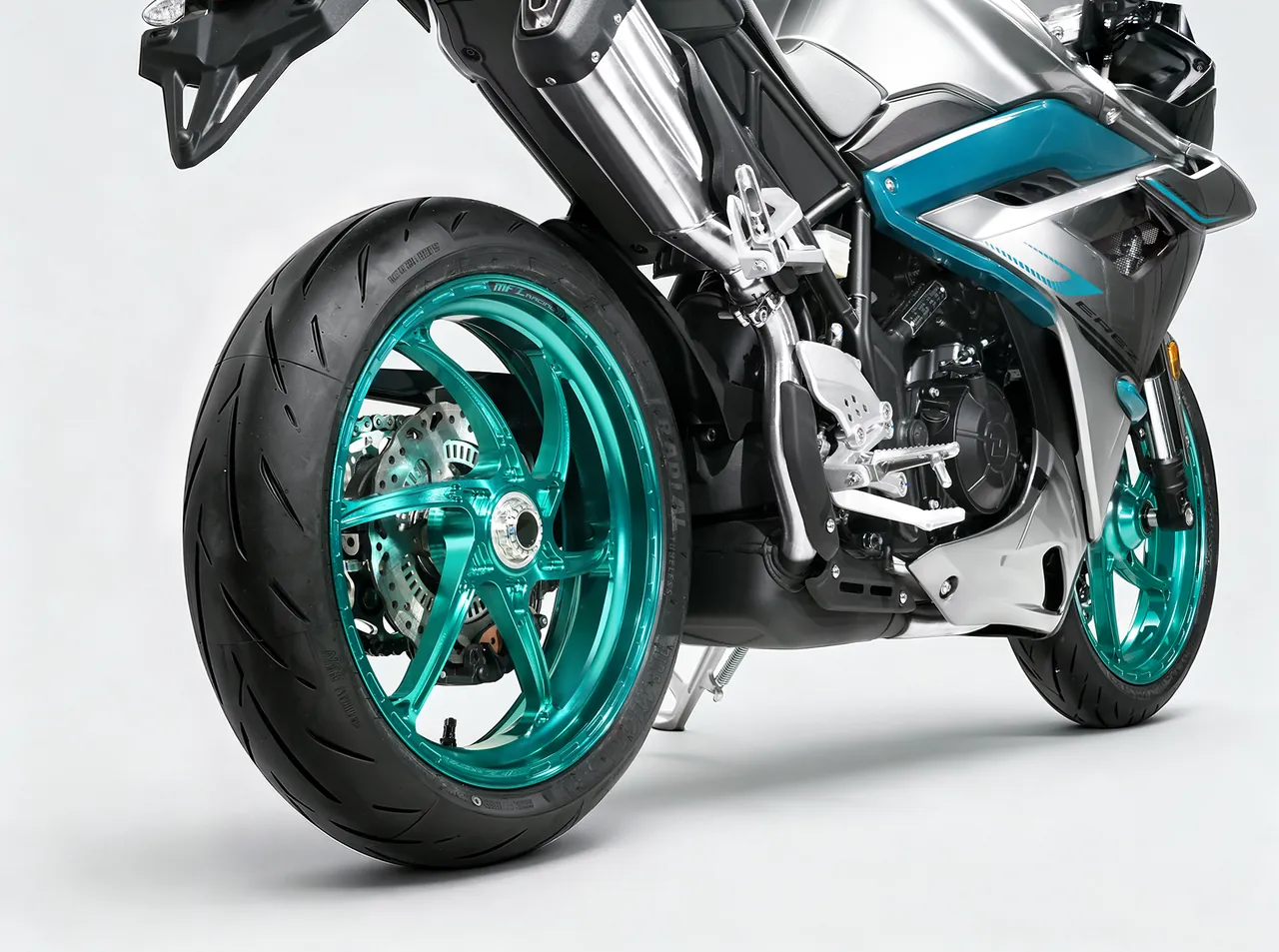 Silver sport bike with a teal forged five-spoke rear wheel