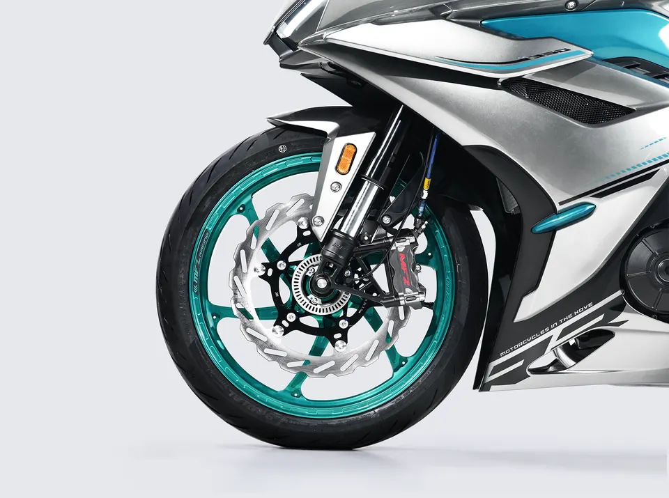 Front wheel with a teal forged rim and an MFZ radial caliper